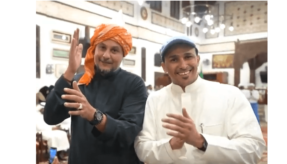 A foreign manager in turban dancing with Saudi employee