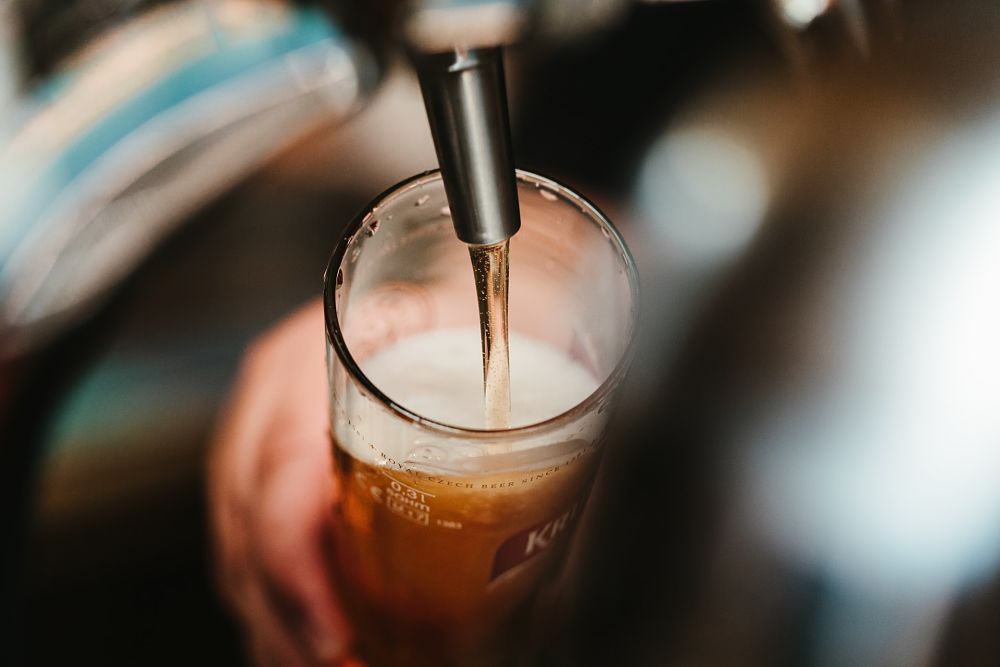 barman pours beer