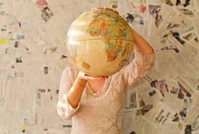 female-expat-holds-globe