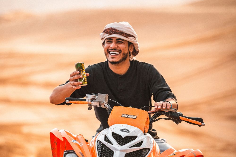 Emirati man riding bike in desert
