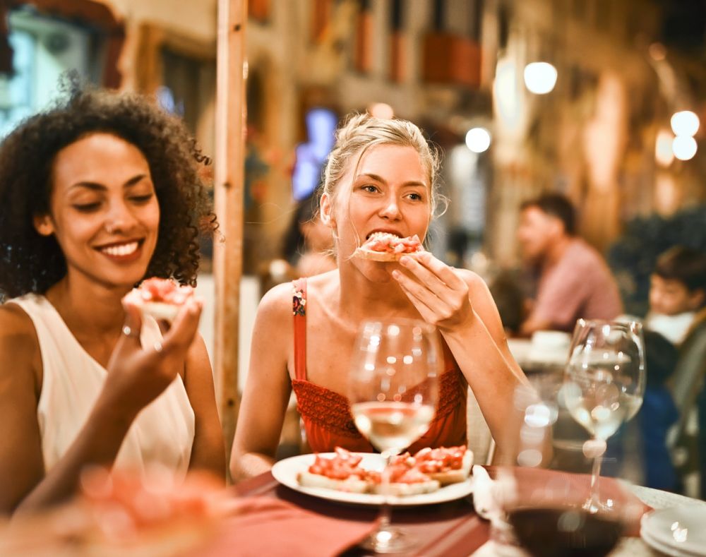 Italian women eating food outside