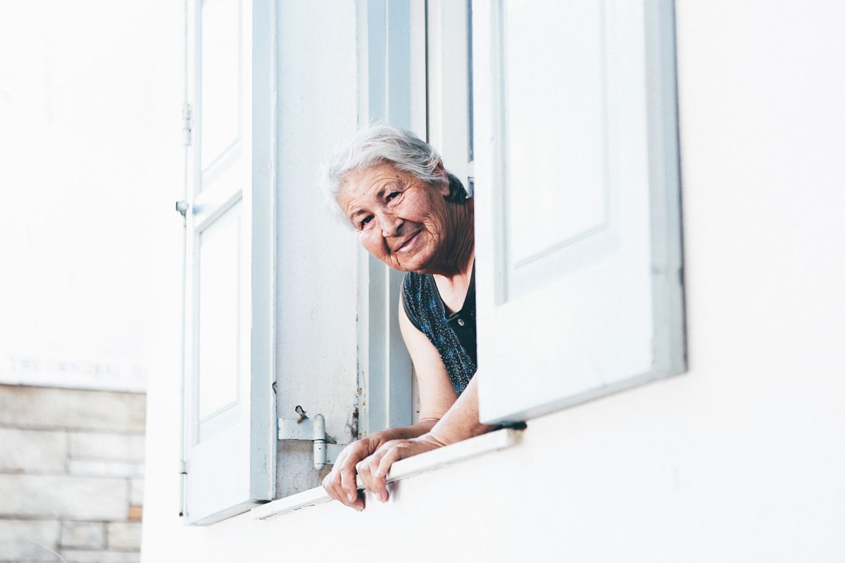 old greek woman looking out of window