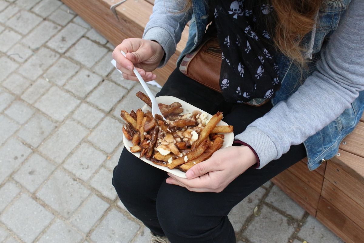 lady eats Poutine