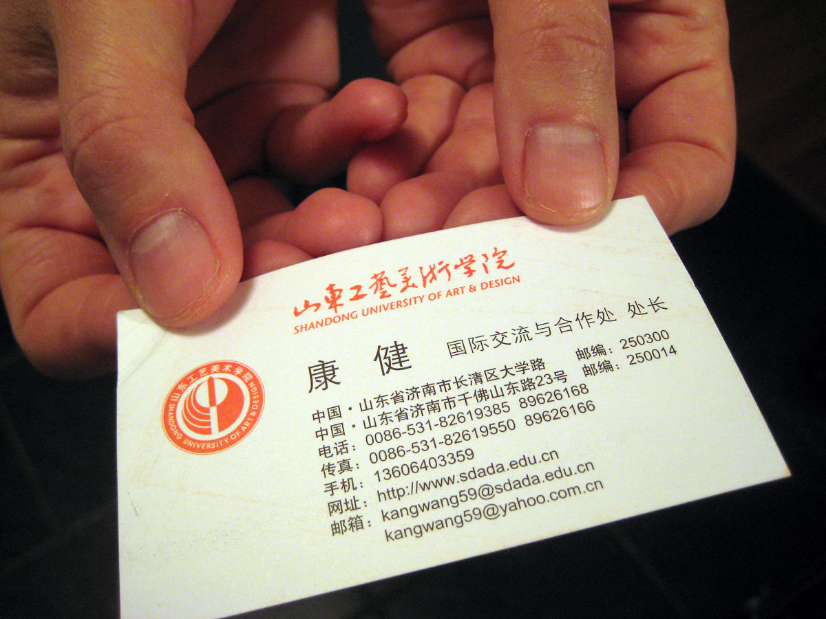 two hands give business card china