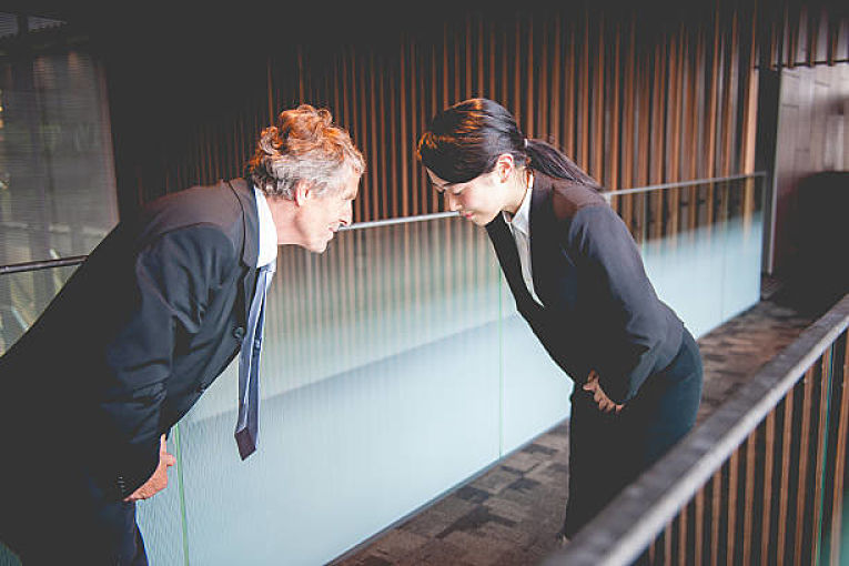 white man bowing to japanese